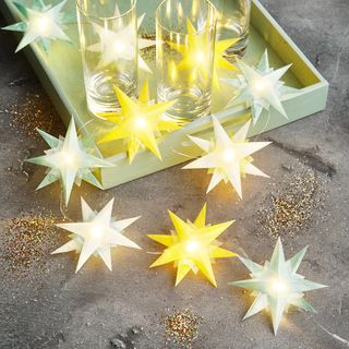 Folding a sparkling chain of lights with stars