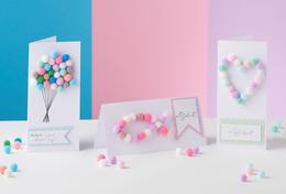 Cards with colourful pompoms